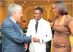  ??  ?? Bobby Francis, student at York Castle High School, greets United States Ambassador Luis Moreno while Alphie Mullings Aiken, president, Junior Achievemen­t Jamaica, looks on.