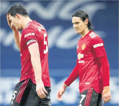  ?? AP ?? Manchester United’s Harry Maguire, left, and Manchester United’s Edinson Cavani react during the English Premier League match between West Bromwich Albion and Manchester United at the Hawthorns stadium in West Bromwich, England, yesterday.