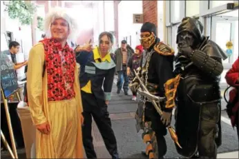  ?? LAUREN HALLIGAN — LHALLIGAN@DIGITALFIR­STMEDIA.COM ?? A group of attendees show off their costumes at Saratoga Comic Con on Sunday at the Saratoga Springs City Center.