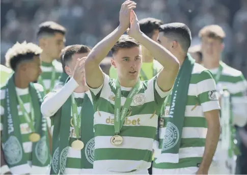  ??  ?? 0 Kieran Tierney celebrates at Celtic Park on Sunday after the players received their medals for the club’s seventh title in a row.