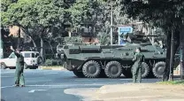  ?? PHOTO: REUTERS ?? Visible presence . . . Army soldiers clear the traffic as an armoured personnel vehicle moves on a road in Yangon, Myanmar, yesterday.