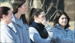  ?? J. SCOTT APPLEWHITE / AP ?? Animal keepers at the Smithsonia­n’s National Zoo in Washington, DC, watch on Tuesday as Bao Bao, the zoo’s 3-year-old panda, is loaded onto a truck to begin her trip to China to join a panda breeding program. She arrived in Chengdu on Wednesday night.