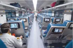  ?? — AFP ?? Passengers travel onboard the Tejas Express luxury train during its first journey between Mumbai and Goa.