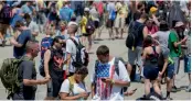  ??  ?? Festival goers wander the grounds at the Pokemon Go Fest in Chicago on Saturday.