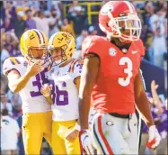  ?? Matthew Hinton / Associated Press ?? LSU kicker Cole Tracy (36) celebrates a field goal with punter Josh Growden as Georgia defensive back Tyson Campbell walks away in the second half Saturday.