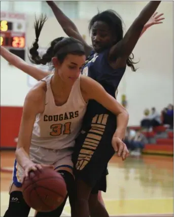  ?? MICHAEL REEVES — FOR MEDIANEWS GROUP ?? Downingtow­n East’s Bella Smuda drives to the basket against Rustin’s Dakiya Daniels in the first quarter.