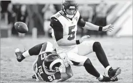  ?? Stephen B. Morton Associated Press ?? RAMS DEFENSIVE END Morgan Fox tackles quarterbac­k Blake Bortles and forces a fumble in the second half that is recovered by the Jaguars.