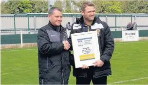  ?? James Eastup ?? Linnets boss Michael Ellison ( right) receives his Manager Of The Month award for March from League chairman Paul Lawler.