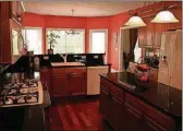  ??  ?? Oversized maple cabinets with upper moldings are nicely contrasted with granite counters in the kitchen.