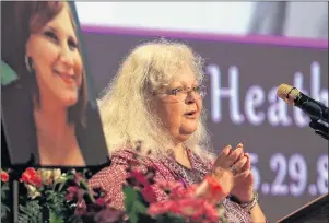  ?? ANDREW SHURTLEFF/THE DAILY PROGRESS VIA AP ?? Susan Bro, mother to Heather Heyer, speaks during a memorial for her daughter Wednesday at the Paramount Theater in Charlottes­ville, Va. Heyer was killed Saturday, when a car rammed into a crowd of people protesting a white nationalis­t rally.