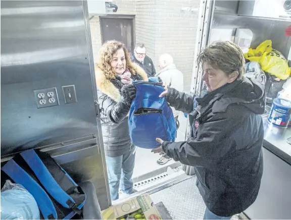  ?? BOB TYMCZYSZYN/STANDARD STAFF ?? Dr. June Mergl and Eugene Oatley, members of the Rotary Club of Niagara Falls, on Friday delivered backpacks filled with essential items to Pastor Lt. Curtis Metcalf and outreach worker Karen Johnson. The backpacks will be donated to those less...