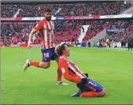  ?? JAVIER BARBANCHO / REUTERS ?? Antoine Griezmann celebrates with Diego Costa after scoring Atletico Madrid’s first goal against Celta Vigo at Wanda Metropolit­ano Stadium in Madrid on Sunday.