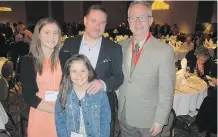  ??  ?? From left are Madyson and Olivia Singleton with proud dad David Singleton, keynote speaker; and Hugh McGeary of Catholic Family Services.