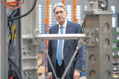  ?? Picture: PA. ?? Chancellor Philip Hammond looks at a section of a deep sea drill rig during a visit to the Lyell Centre for Natural Environmen­t Research at Heriot-Watt University, Edinburgh.