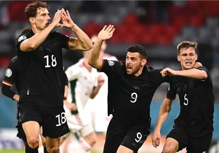  ??  ?? Germany's Leon Goretzka, left, celebrates with teammates after scoring his side's second goal during the Euro 2020 soccer championsh­ip group F match between Germany and Hungary at the Allianz Arena in Munich, Germany,Wednesday, June 23, 2021. (Lukas Barth/Pool Photo via AP)