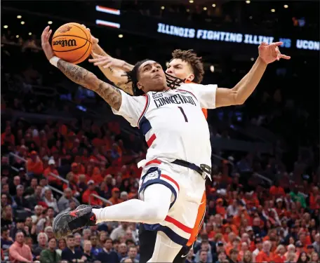  ?? (STAFF PHOTO — STUART CAHILL/BOSTON HERALD ?? Connecticu­t Huskies guard Solomon Ball (1) has his shot blocked by Illinois forward Coleman Hawkins during UConn’s blowout victory at the TD Garden in Boston.