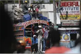  ?? MATIAS DELACROIX — THE ASSOCIATED PRESS ?? Commuters ride a Tap Tap bus in Port-au-Prince, Haiti, on Wednesday.