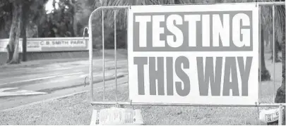  ?? CARLINE JEAN/SOUTH FLORIDA SUN SENTINEL ?? A sign directs people to the COVID-19 drive-through testing site at C.B. Smith Park in Pembroke Pines.