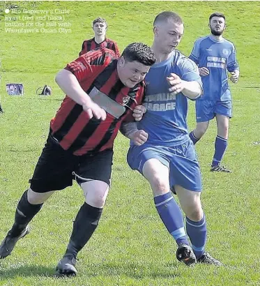  ??  ?? Bro Goronwy’s Chris Byast (red and black) battles for the ball with Waunfawr’s Osian Glyn