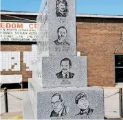  ?? JIM BECKEL, THE OKLAHOMAN ARCHIVES] [PHOTO BY ?? A monument at the Freedom Center, 2609 N Martin Luther King Ave., honors local and national civil rights leaders. The former Mobil filling station was converted for use by the NAACP Youth Council in 1965. Damaged in a 1968 firebombin­g, the building has...