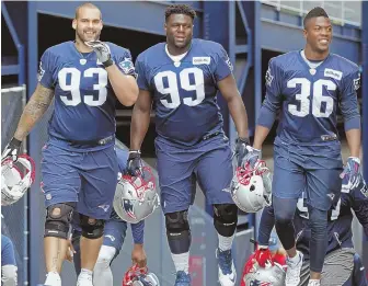  ?? STAFF PHOTO BY JOHN WILCOX ?? MAKING HIS PRESENCE KNOWN: Lawrence Guy (left) walks out to a recent practice with Patriots defensive teammates Vincent Valentine (99) and Brandon King.