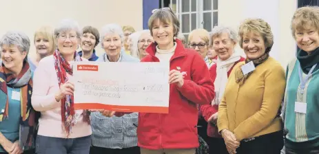  ??  ?? Christ’s Hospital Choral Society presents a cheque for £1016 to Medical Detection Dogs