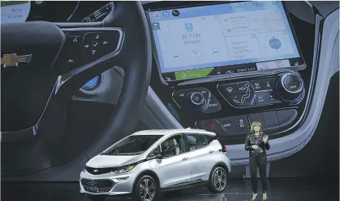  ?? ALEX WONG / GETTY IMAGES ?? General Motors CEO Mary Barra introduces the new Chevy Bolt EV at the Consumer Electronic­s Show in Las Vegas on Wednesday. U. S. vehicle launches more often take place at next week’s Detroit Auto Show.