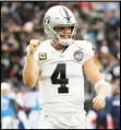  ?? Associated Press ?? FRIGID — Oakland Raiders quarterbac­k Derek Carr celebrates after a touchdown by running back DeAndre Washington during the second half of a game against the Chargers on Sunday in Carson.