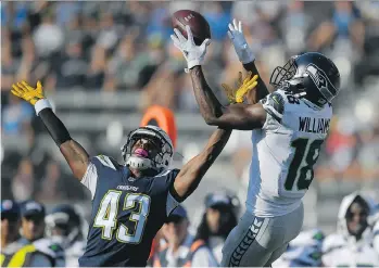  ?? MARK J. TERRILL/THE ASSOCIATED PRESS ?? Seattle Seahawks wide receiver Kasen Williams goes up for a catch over Los Angeles Chargers cornerback Michael Davis during Sunday’s NFL pre-season game in Carson, Calif.