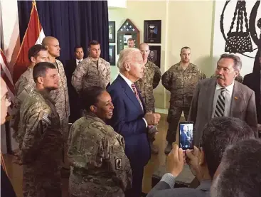 ?? Josh Lederman / Associated Press ?? Vice President Joe Biden meets on Thursday with U.S. personnel serving in Iraq. His surprise visit was the third such trip this month by a high-level official, showing a sense of urgency as Iraq’s struggles continue.