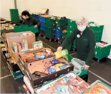  ??  ?? Volunteers Tomiko Mitsuoka and Shelley Collins from Slough Foodbank. Ref:133225-5