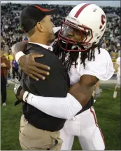  ?? THE ASSOCIATED PRESS ?? Despite the nature of their relationsh­ip, Stanford’s Richard Sherman hugs then-Stanford head coach Jim Harbaugh after a Cardinal victory in 2010.