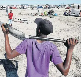  ?? /Esa Alexander ?? Time to rebuild: Residents of the Empolweni informal settlement in Khayelitsh­a start to rebuild their shacks after they won a court case against the City of Cape Town. The city announced on Monday that it had returned seized building material to 49 households that were removed from municipal land in the middle of the lockdown. On Friday, the high court in Cape Town ruled that residents of Empolweni could return to the land where their shacks were demolished.
