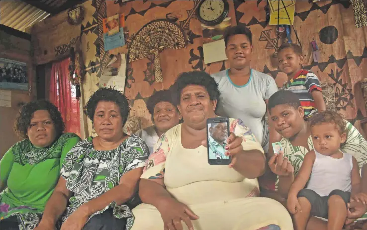  ?? Photo: Mereleki Nai ?? Merewalesi Sigavere(holding phone), wife of late Aseri Doidoi and her family at their home in Vaturu, Nadi.