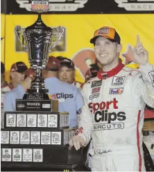  ?? AP PHOTO ?? GRAND PRIZE: Denny Hamlin poses with the trophy after winning last night’s Southern 500 at Darlington.