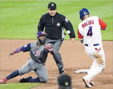  ?? Gregory Bull Associated Press ?? U.S. SECOND BASEMAN Josh Harrison can’t reach pitcher Marcus Stroman’s errant throw as Puerto Rico catcher Yadier Molina is safe at second in the third inning at Petco Park. Stroman was charged with an error.