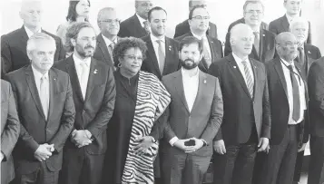  ?? GUSTAVO GARELLO AP ?? From left to right in the front, Argentina President Alberto Fernández; Argentina’s minister of foreign affairs, Santiago Cafiero; Prime Minister of Barbados Mia Mottley; Chile President Gabriel Boric; Cuba’s leader, Miguel Díaz-Canel and Haitian Prime Minister Ariel Henry, with other foreign leaders, during the Summit of the Community of Latin American and Caribbean States (CELAC) in Buenos Aires, Argentina, on Tuesday.