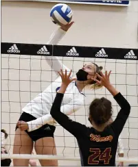  ?? DREW ELLIS - MEDIANEWS GROUP ?? Marian’s Sarah Sylvester, left, spikes the volleyball past Mercy’s Lauren Mullen in Marian’s 25-19, 25-15, 25-15 win on Thursday.