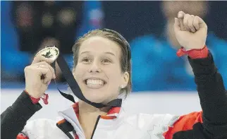  ?? GRAHAM HUGHES/THE CANADIAN PRESS ?? Marianne St-Gelais celebrates with her gold medal after winning the women’s 500-metre final at the ISU World Cup short-track speedskati­ng competitio­n in Montreal Sunday.