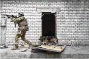  ?? MSTYSLAV CHERNOV / AP ?? A Ukrainian serviceman patrols during a reconnaiss­ance mission in a recently retaken village on the outskirts of Kharkiv, east Ukraine, on Saturday.