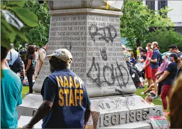  ?? CURTIS COMPTON / CCOMPTON@AJC.COM ?? A diverse group of local residents and protesters participat­e in a rally Wednesday calling on DeKalb County to follow a judge’s order to swiftly remove the Confederat­e monument from Decatur Square.