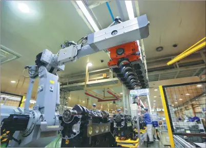  ?? PHOTOS PROVIDED TO CHINA DAILY ?? Customized assembly robots at the Weichai Group speed up the company’s engine production in the Weifang Hi-tech Industrial Developmen­t Zone.