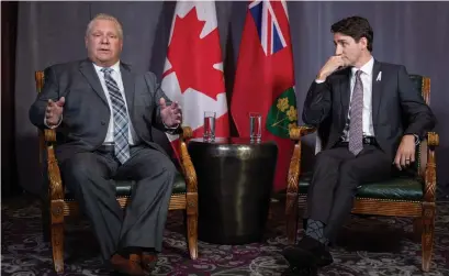  ?? PAUL CHIASSON THE CANADIAN PRESS ?? Premier Doug Ford meets with Prime Minister Justin Trudeau before the first ministers’ meeting when Ford said he wanted to focus on Ottawa’s “job-killing carbon tax,” as well as the impact of the General Motors plant closure in Oshawa.