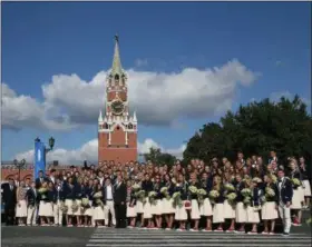  ?? YEKATERINA SHTUKINA — THE ASSOCIATED PRESS ?? Russian Prime Minister Dmitry Medvedev, center, poses with Russian Olympic medalists at a presentati­on ceremony of BMW cars in the Kremlin, with the Spassky Tower in the background, in Moscow, Russia, Thursday. Russia gave out dozens of BMW luxury cars...