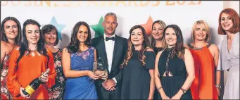  ??  ?? Staff at Hinckley and Rugby Building Society accept the commitment to developing people award at the East Midlands Leicesters­hire Chamber of Commerce Business Awards.