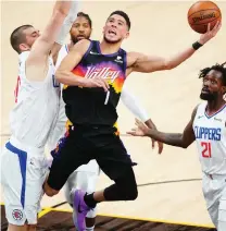  ?? (Mark J. Rebilas/USA Today via Reuters) ?? PHOENIX SUNS guard Devin Booker (1) goes to the basket against the Los Angeles Clippers on Sunday.