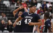  ?? ERIC BONZAR— THE MORNING JOURNAL ?? The Lorain Titans celebrate a win during the Unified Special Olympics Basketball Tournament March 21.