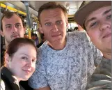  ??  ?? Navalny, center, before the poisoning