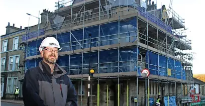  ?? ?? ● Chairperso­n of Valley Heritage Stephen Anderson outside the former Lancashire and Yorkshire Bank in Bacup, which is being renovated for co-working space and flats.