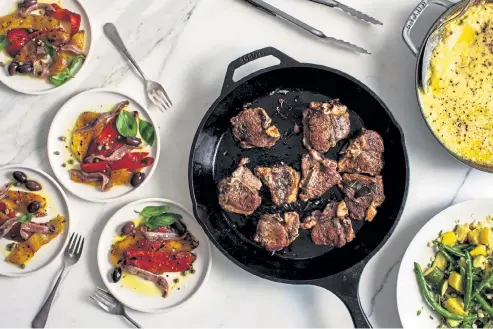  ?? Andrew Scrivani, © The New York Times Co. ?? From left: Roasted Peppers With Capers, Olives and Anchovies; pan- fried lamb chops; green beans with zucchini, corn and summer squash; and Baked Polenta With Ricotta and Parmesan.